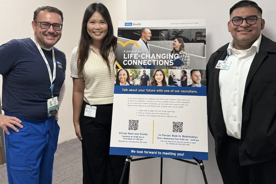 DGSOM community members standing with a recruitment poster