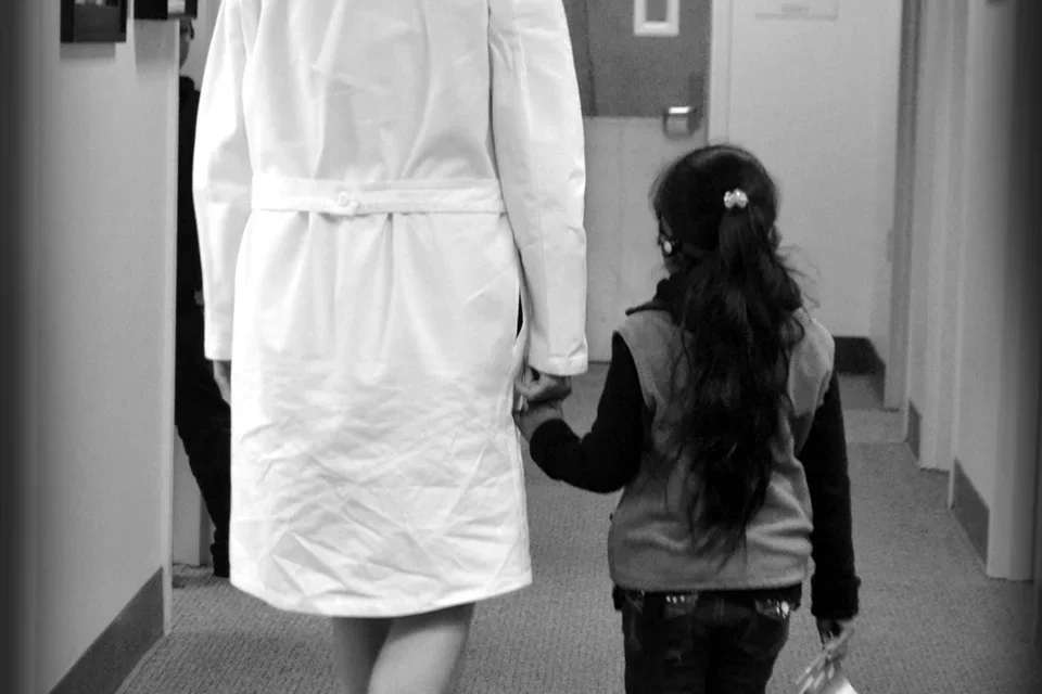 Dr. Justine Lee a cleft lip and palate specialist, pictured with a pediatric patient