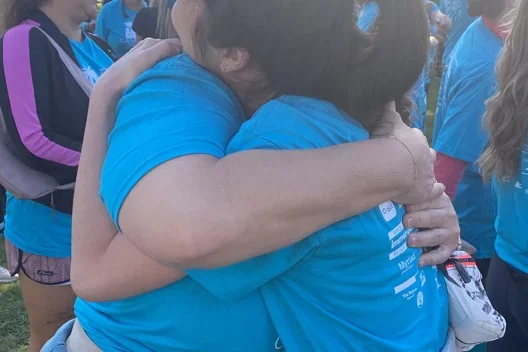 Dr. Tiffany Lai, who treats HPV and Cervical Cancer, hugging with a patient