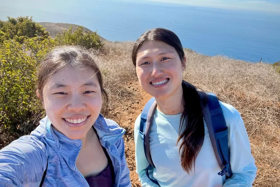 Xin Qi and a friend on a hike