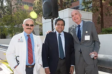 A group of people outdoors embracing each other 