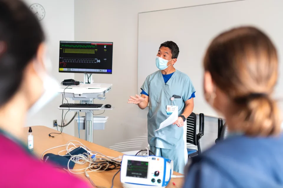 A facilitator leads a simulation session as a foundational learning for 4th year students.