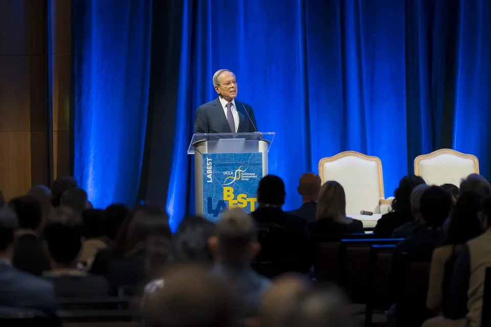 Arie Belldegrun, MD, chair in urologic oncology, speaking at a podium.