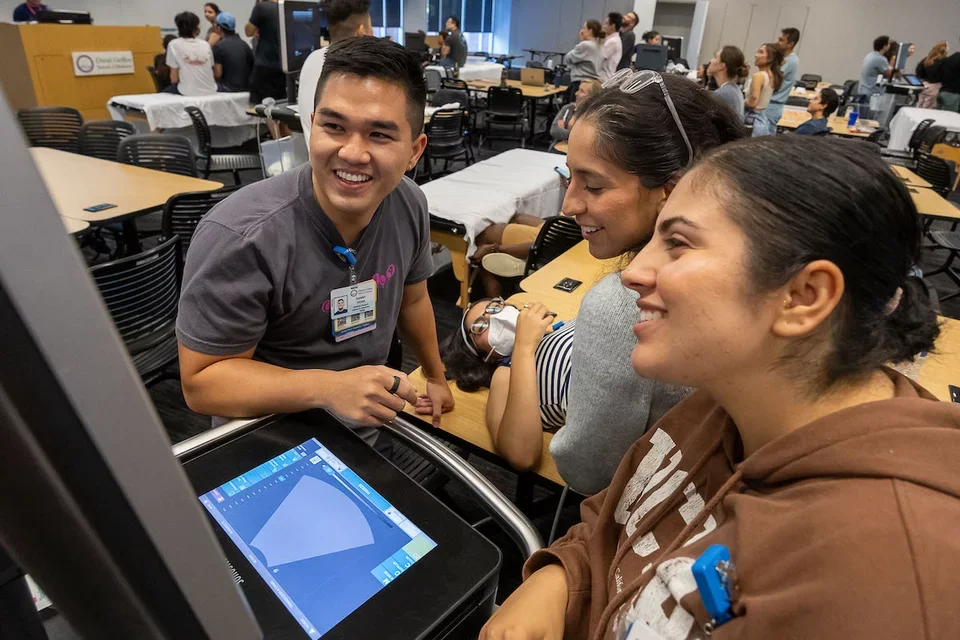 First-general medical student Danny Đoàn, pictured completing a point of care ultrasound (POCUS) training exercise with classmates. 