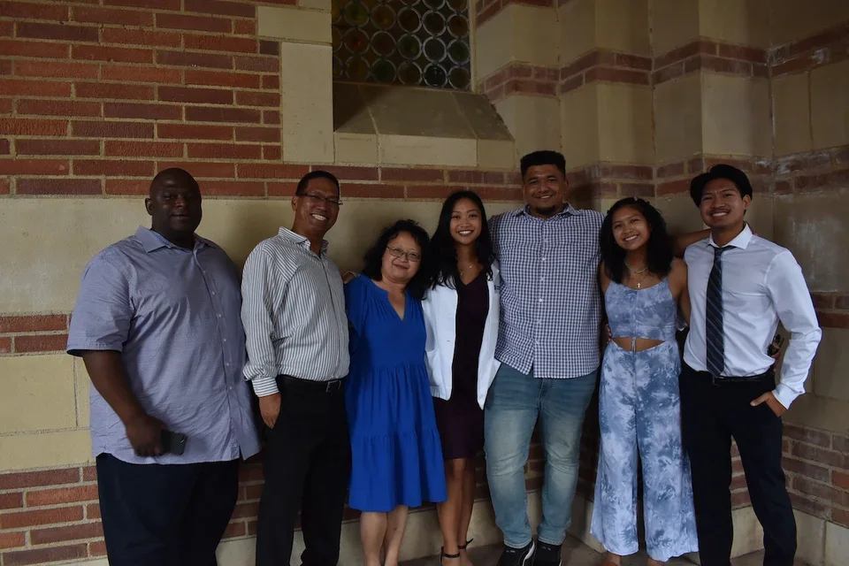 Medical student Melanie Ramirez smiling with her family during her White Coat ceremony