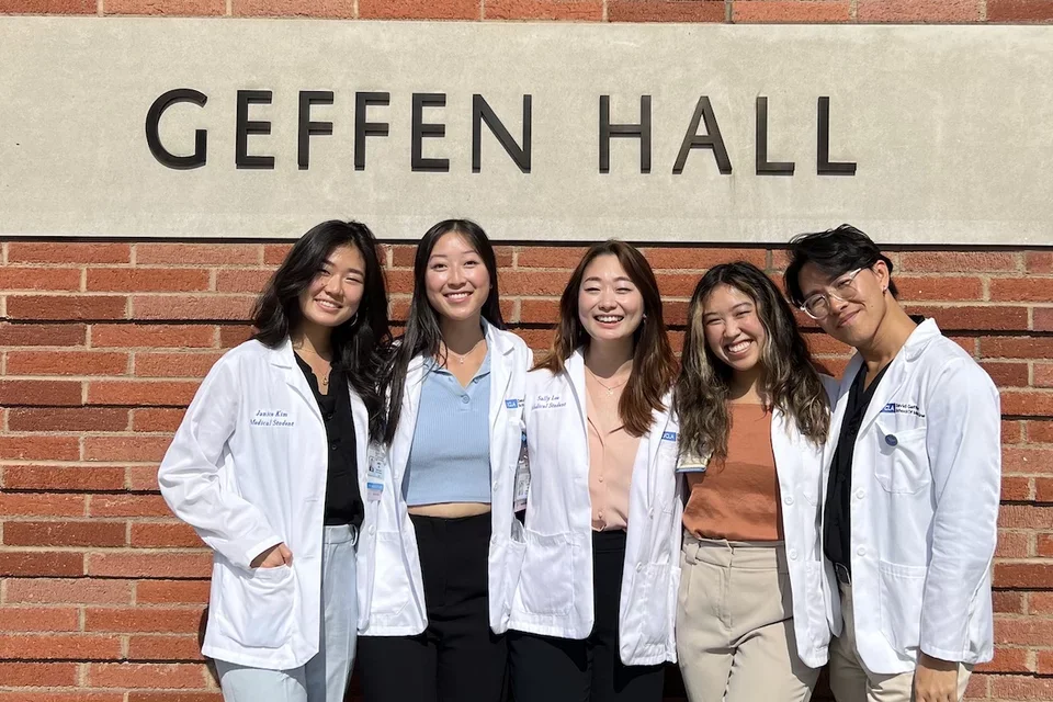 Medical student Clara Đỗ Trần Nguyễn, pictured in front of Geffen Hall with med school classmates, shares her story of becoming a doctor