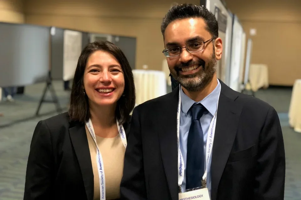 Dr. Canales and a colleague at a poster presentation