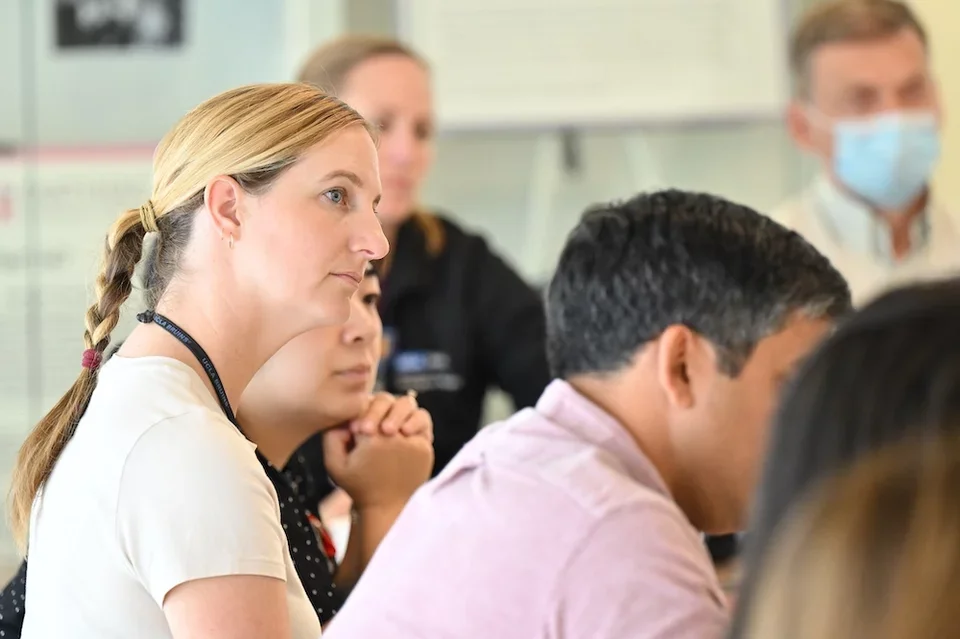 four people listening