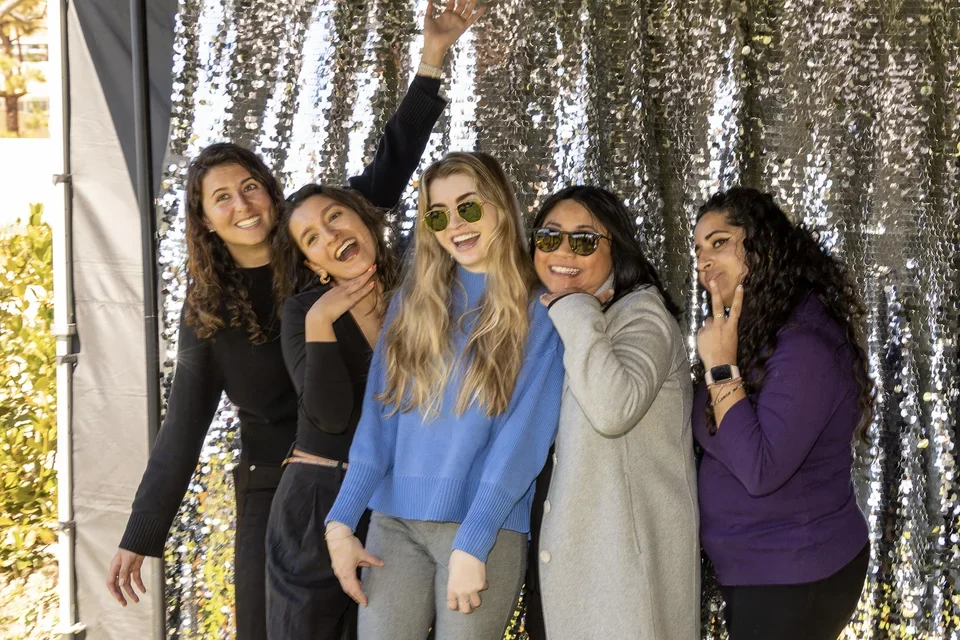 Five female coworkers in a photo booth