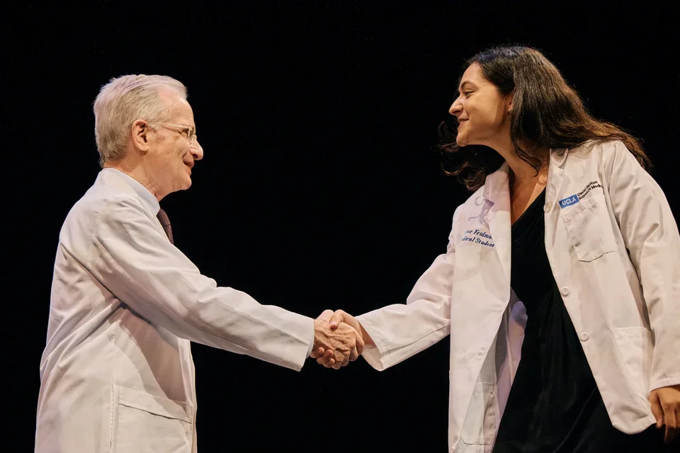 David Geffen School of Medicine Dean Dubinett shaking hands with an incoming med student and welcoming them into the program.