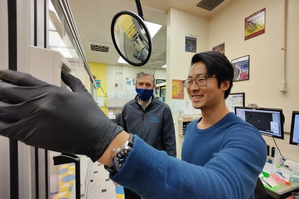 Justin Pi, pictured here with a colleague in his lab, shares his experience of getting a PhD at UCLA.