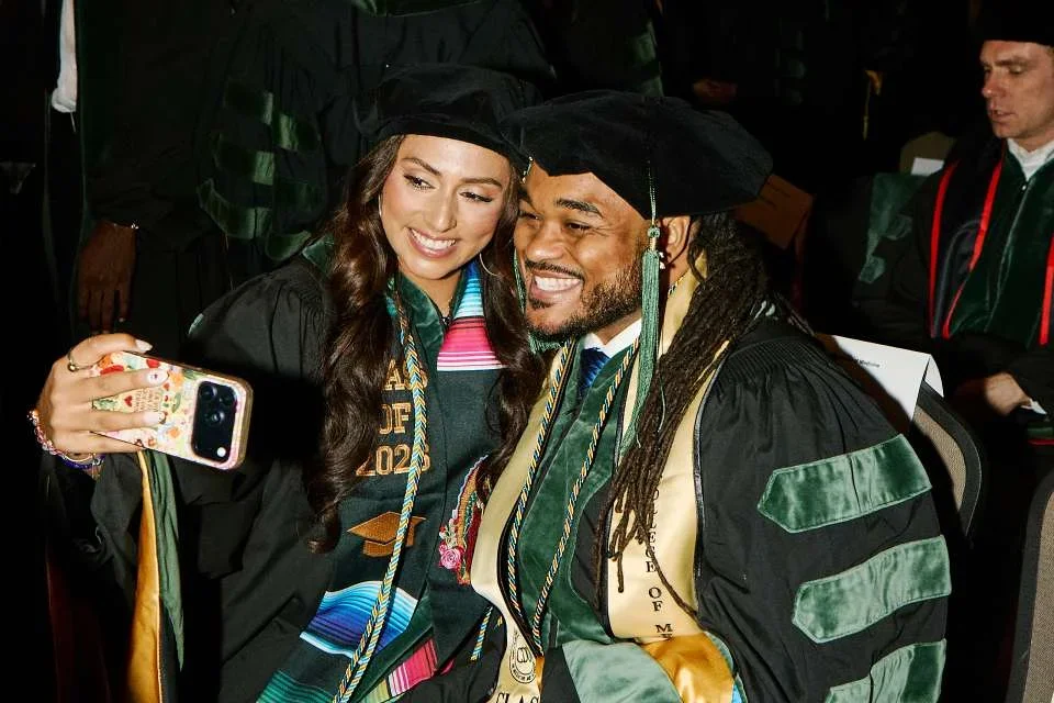 Jimenez-Tapia and a fellow classmate during DGSOM 2026 commencement ceremony.
