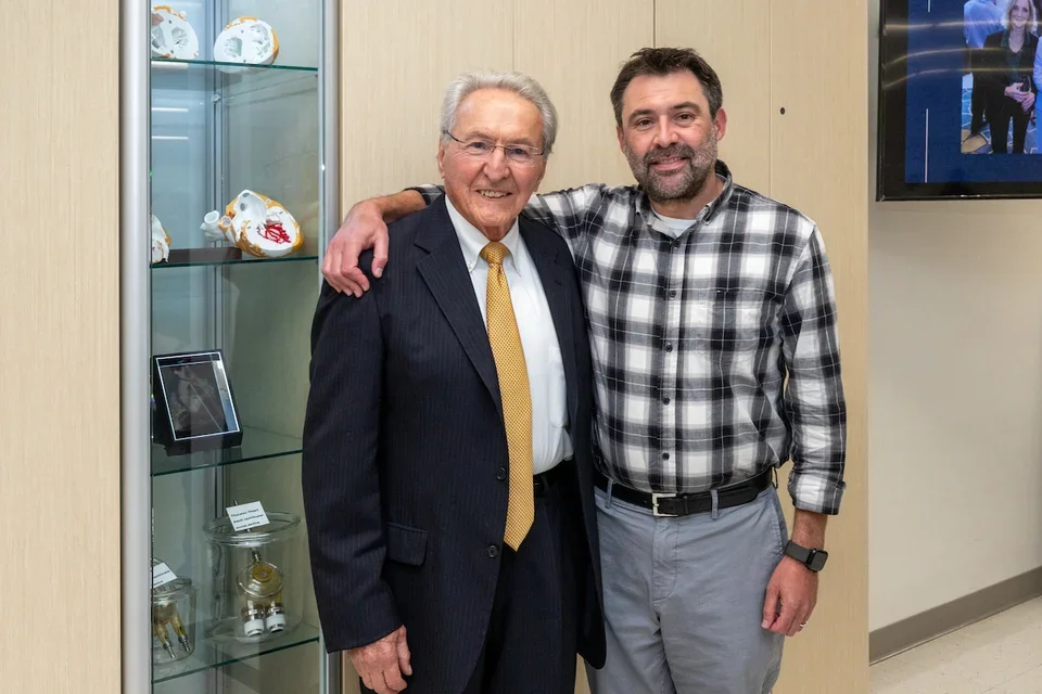 Drs. Michael Fishbein and Gregory Fishbein stand in front of the heart collection