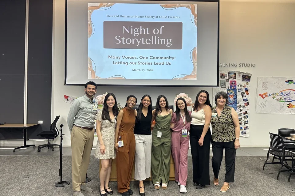 GHHS members standing in front of Night of Storytelling presentation.