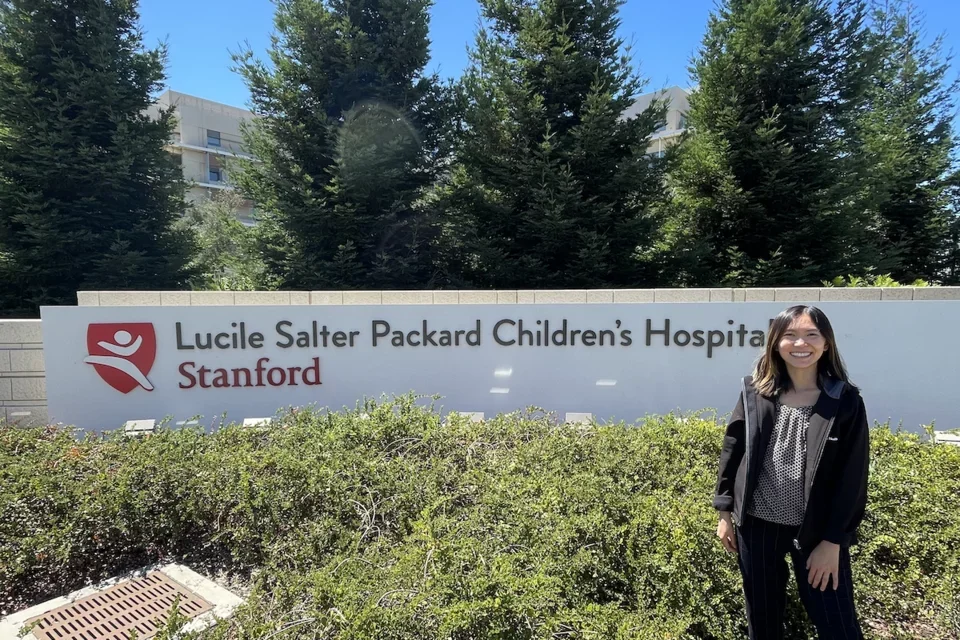 Molecular, Cellular, and Integrative Physiology (MCIP) PhD program student Rochelle Lai, pictured in front of Stanford Children’s