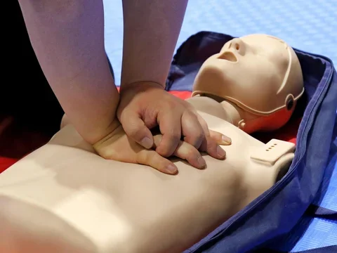 Man performing CPR on a mannequin.