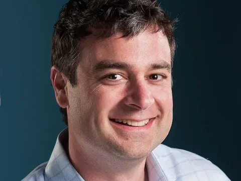 Man's face and shoulders smiling