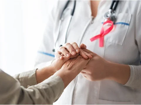 doctor holding hands with pink ribbon
