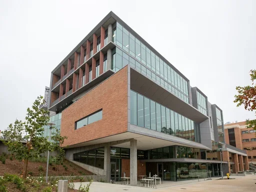 UCR SOM Building with red brick on one side and glass on another side.