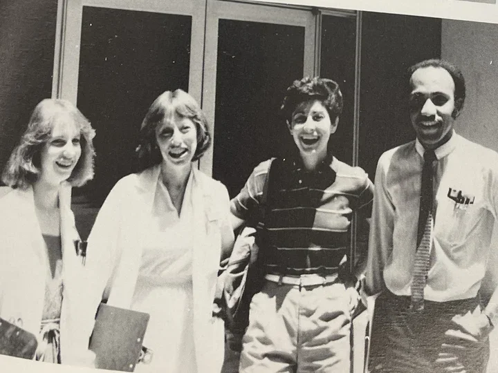 students standing in front of a doorway