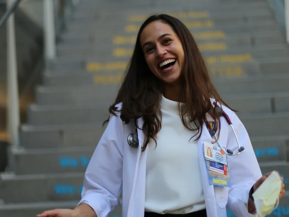 A DGSOM resident on Geffen Hall stairs