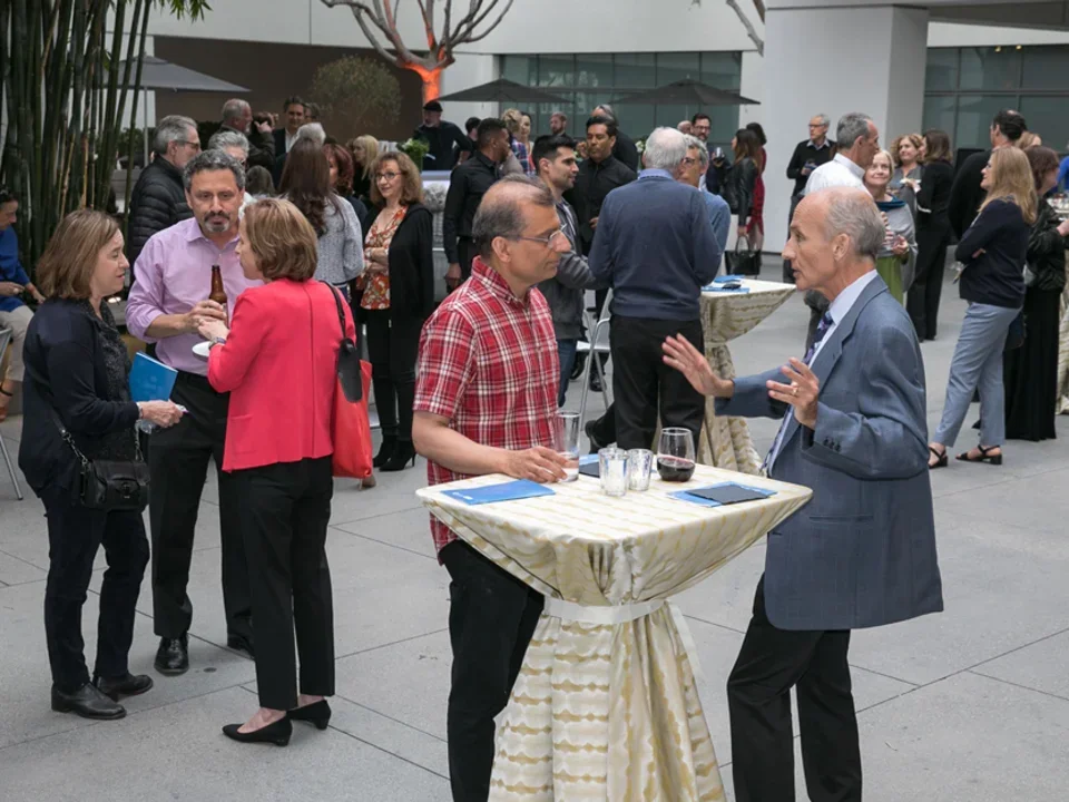 DGSOM community members mingling at an art and neuroscience event.