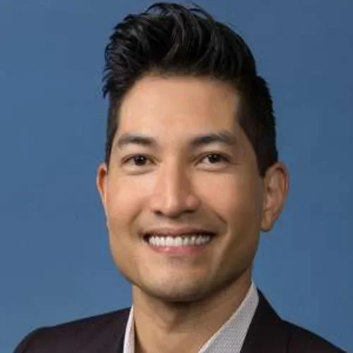 Dr. S. Brandon Ito portrait in front of blue backdrop