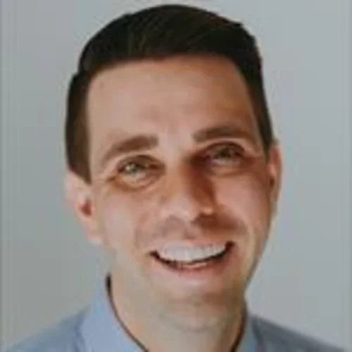 Dr. Tyler Larsen smiling portrait in front of white backdrop