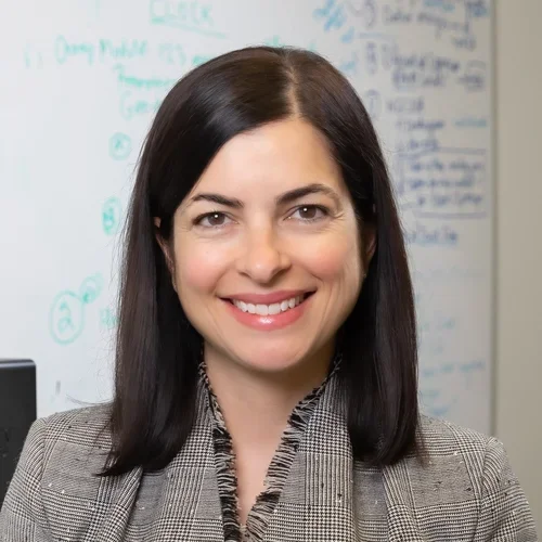 woman in grey suit in office