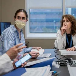 Dr. Terri Getzug and Dr. Wayne Grody, discussing a Familial Mediterranean Fever case 