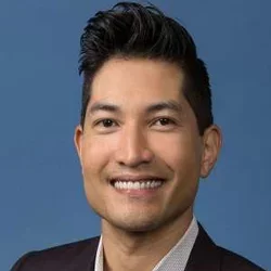 Dr. S. Brandon Ito portrait in front of blue backdrop