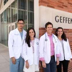 First cohort of the David Geffen Medical Scholarship pose in front of Geffen Hall