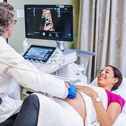 Obstetricians vs Gynecologists What's the Difference? Pregnant woman receiving ultrasound