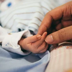 Parent and baby closeup of hands