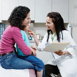 A Day in the Life of a Pediatrician Doctor Talking to Young Patient 