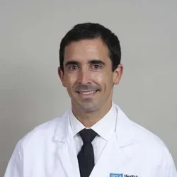 Dr. Bergman wearing a white coat.