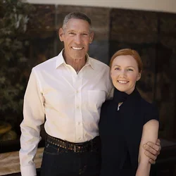 Gary Michelson, left, and Aya Michelson stand with arms around each other