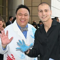 Dr. Steven J. Jonas and cancer survivor Sina Sinbari celebrate the $400,000 Hyundai Scholar Hope grant for pediatric cancer research.