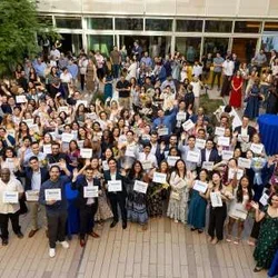 The David Geffen School of Medicine at UCLA class of 2026 holds up their Match Day cards at Geffen Hall at UCLA