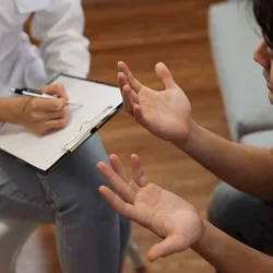 UCLA Medical School Psychologist Psychiatrist With Clipboard Talking to Mental Health Patient