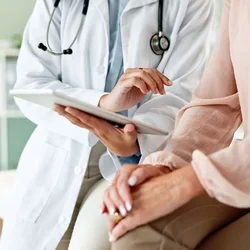 A physician communicating advanced care options with a patient 