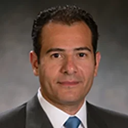 headshot of Dr. Tamer Sallam in a black suite