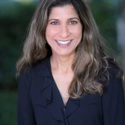 female physician smiling in black shirt