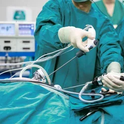 Physicians in scrubs performing a surgical procedure 