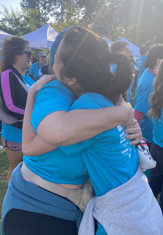 Dr. Tiffany Lai, who treats HPV and Cervical Cancer, hugging with a patient