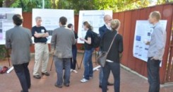 Group of people outdoors in front of PhD in Human Genetics presentation boards