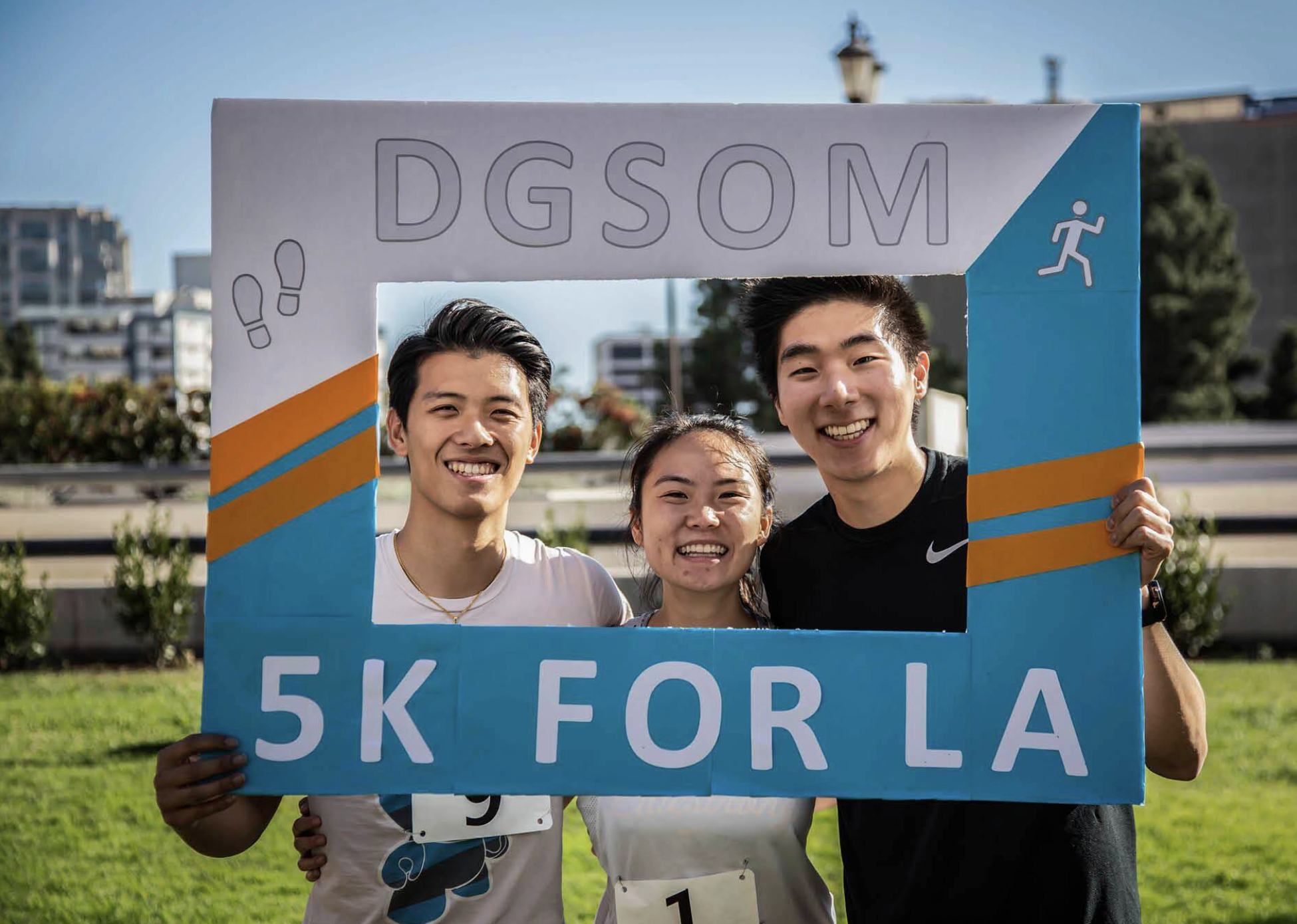 Medical school students with a sign for the 5k for LA put on by students in the medical school.