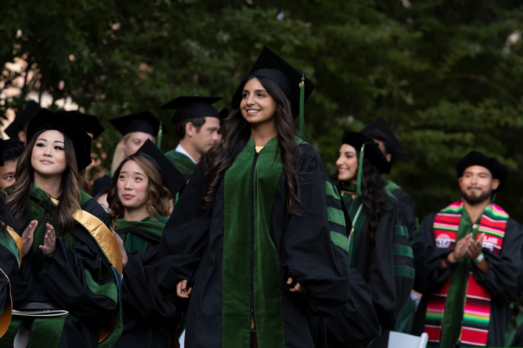 Female medical student graduate walks during commencement ceremony 2022