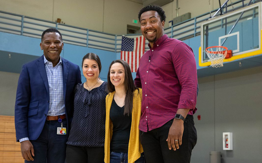 Dr. Olujimi Ajijola, left, with Edward Jean-Louis and Christine Frye and Emily Duncan, who performed CPR on Jean-Louis after he collapsed on the basketball court in 2016.
