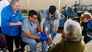 UCLA medical students, under the supervision of attending Dr. Mary Marfisee, providing foot care at Samoshel.